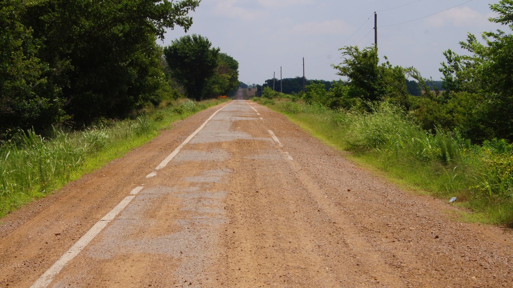 Just wide enough for two Model Ts to pass oncoming, if they would hang their outboard wheels off the curbing.